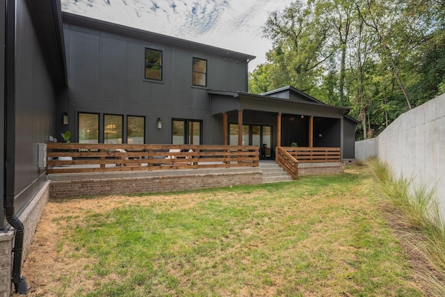 rear view of house with a yard