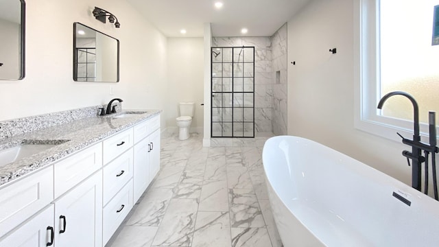 full bathroom with vanity, shower with separate bathtub, and toilet