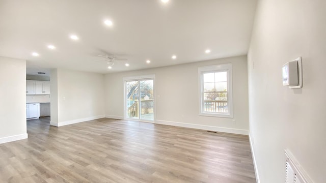 unfurnished room with ceiling fan and light hardwood / wood-style flooring