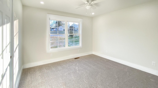 carpeted empty room featuring ceiling fan