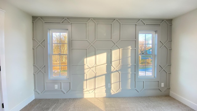 entryway with carpet and a healthy amount of sunlight