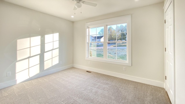 carpeted empty room featuring ceiling fan