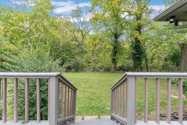 wooden deck featuring a lawn