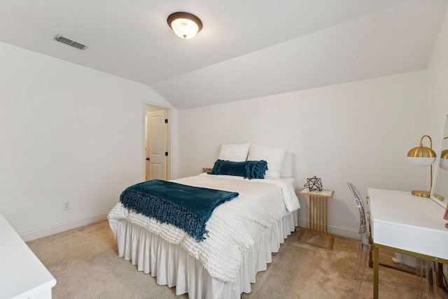 bedroom with lofted ceiling and light carpet