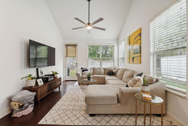 living room featuring lofted ceiling, dark hardwood / wood-style floors, ceiling fan, and a healthy amount of sunlight