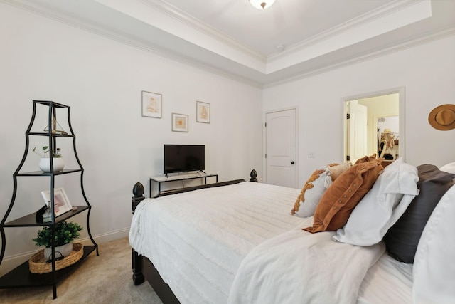 carpeted bedroom featuring a tray ceiling and ornamental molding