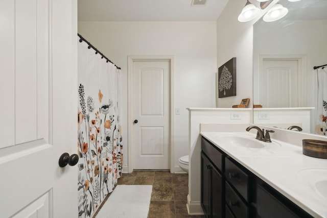 bathroom with vanity, toilet, and walk in shower