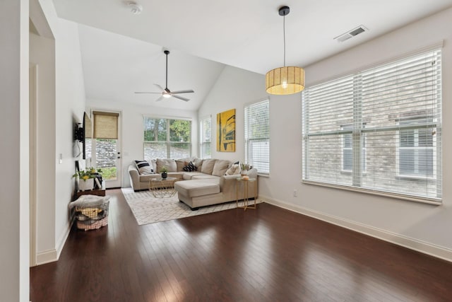 living room featuring ceiling fan, dark wood-type flooring, and vaulted ceiling