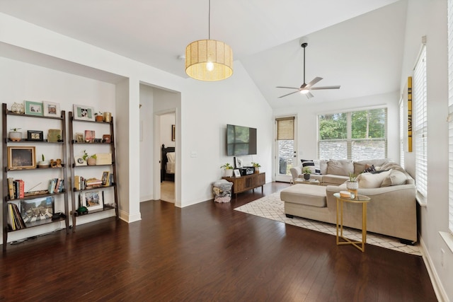 living room featuring dark hardwood / wood-style flooring, vaulted ceiling, and ceiling fan