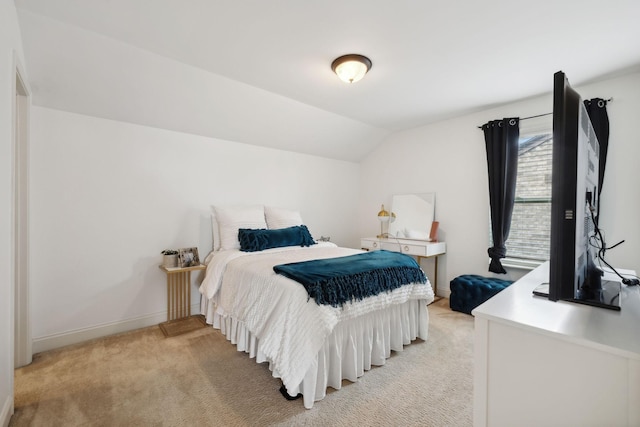 bedroom featuring light colored carpet and vaulted ceiling