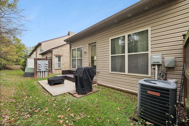 back of house featuring a lawn and cooling unit