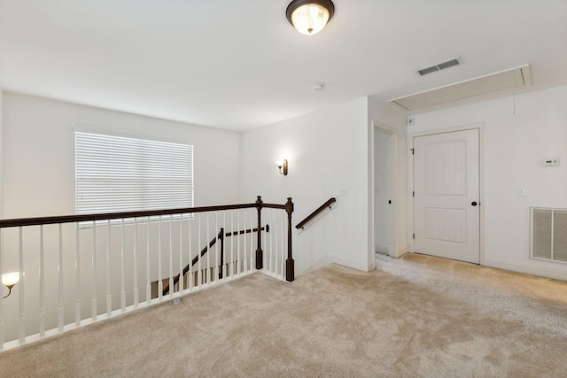 spare room featuring light colored carpet