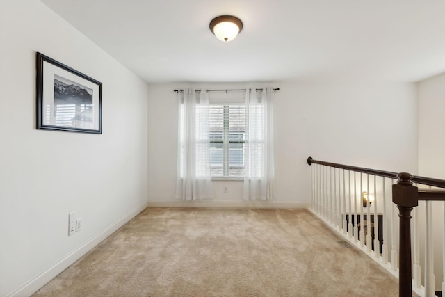 unfurnished room with light carpet