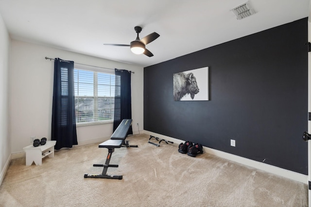 exercise area with ceiling fan and light carpet