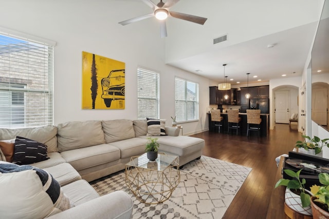 living room featuring ceiling fan and dark hardwood / wood-style floors