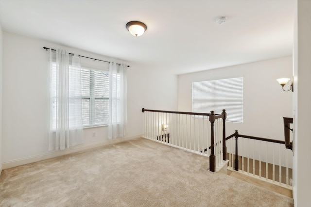 empty room featuring light colored carpet