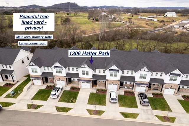 birds eye view of property with a mountain view