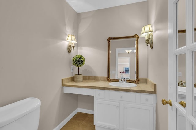 bathroom with tile patterned floors, vanity, and toilet