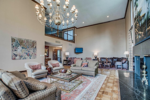 living room with parquet flooring, a high ceiling, ornamental molding, and a notable chandelier