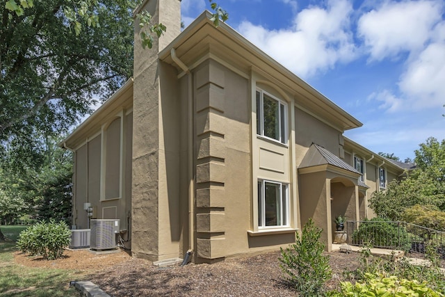 view of side of home featuring central AC unit