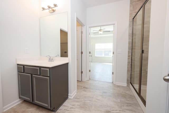 bathroom with an enclosed shower, vanity, and ceiling fan