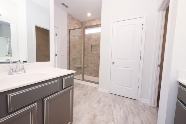 bathroom featuring vanity and a shower with shower door