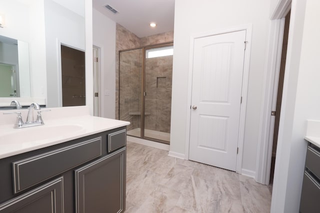 bathroom with vanity and an enclosed shower