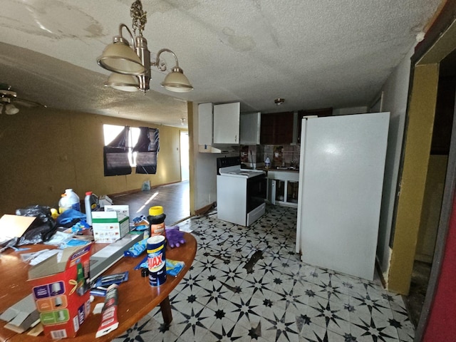 kitchen with white cabinetry and white appliances