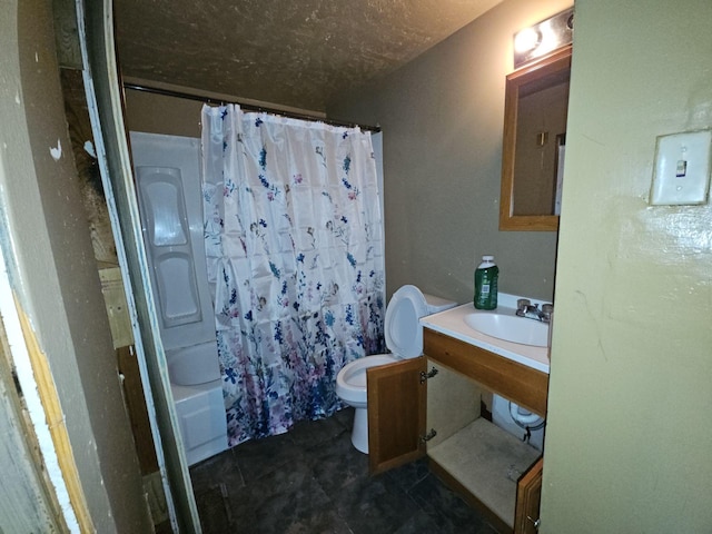 full bathroom with sink, shower / bath combo, and toilet