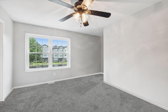 carpeted spare room featuring ceiling fan