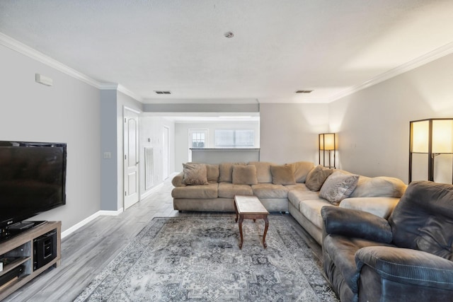 living room with hardwood / wood-style flooring and crown molding