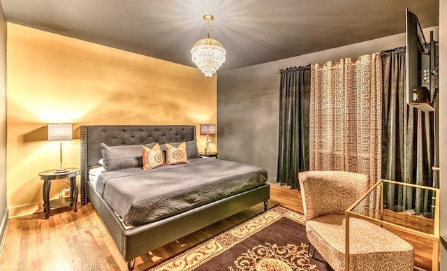 bedroom with wood-type flooring and a notable chandelier