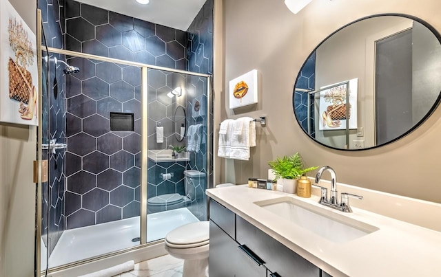 bathroom with vanity, toilet, and an enclosed shower