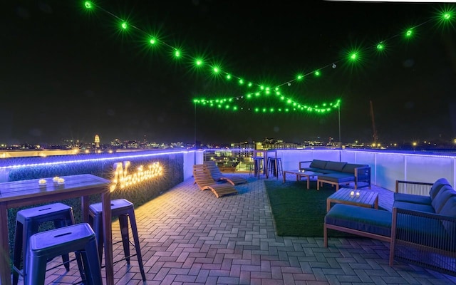 patio at twilight featuring an outdoor hangout area