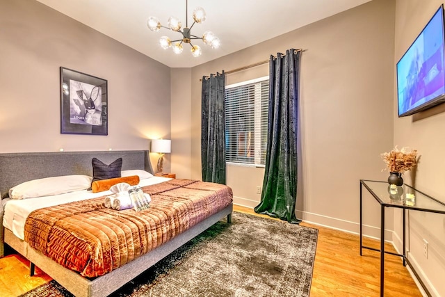 bedroom featuring a chandelier and wood-type flooring