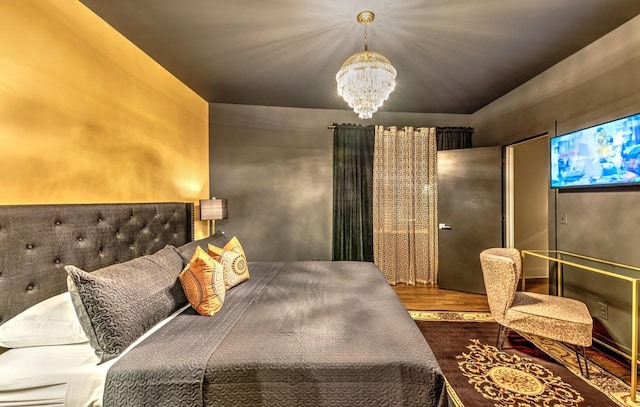 bedroom featuring hardwood / wood-style flooring and an inviting chandelier