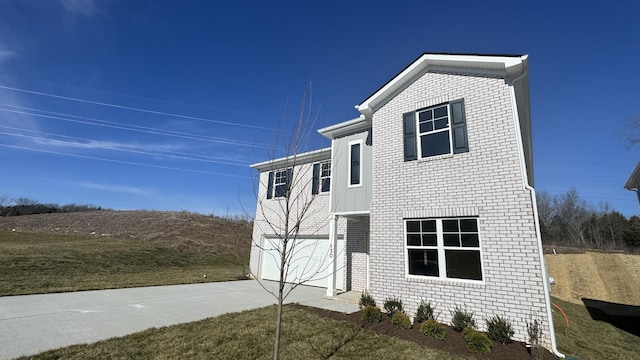 view of side of property with a garage and a yard