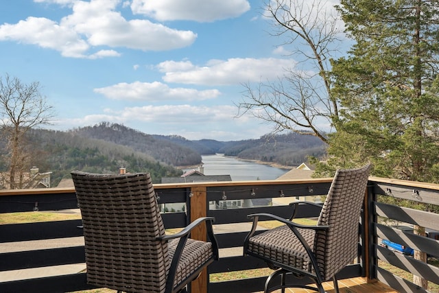 wooden deck featuring a water and mountain view