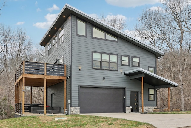 view of front of home with a garage, a jacuzzi, and a wooden deck