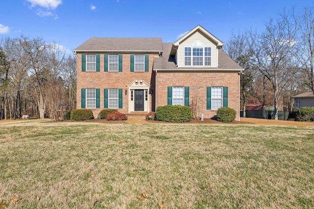 colonial home featuring a front yard