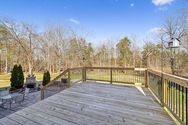 wooden terrace featuring an outdoor fireplace