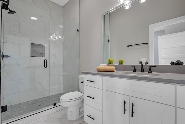 bathroom featuring vanity, toilet, and a shower with door