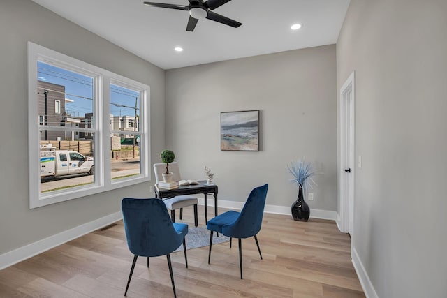 office with ceiling fan and light hardwood / wood-style flooring