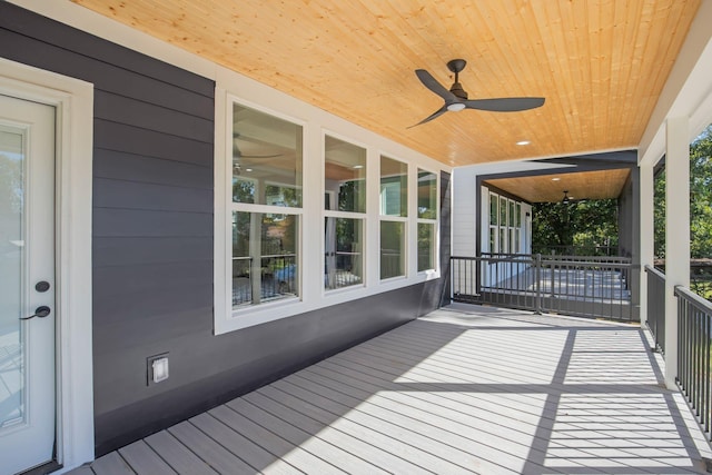 wooden terrace featuring ceiling fan