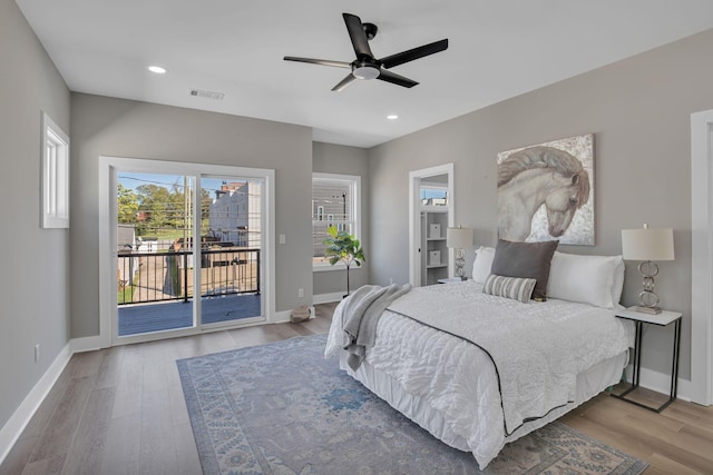 bedroom featuring access to exterior, hardwood / wood-style floors, and ceiling fan