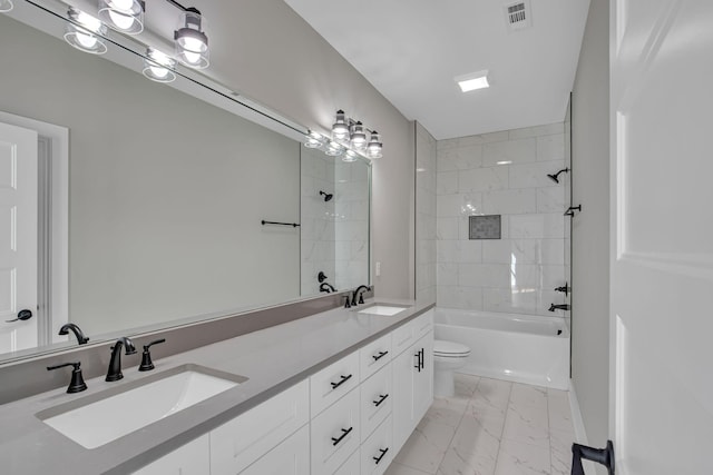 full bathroom featuring vanity, toilet, and tiled shower / bath