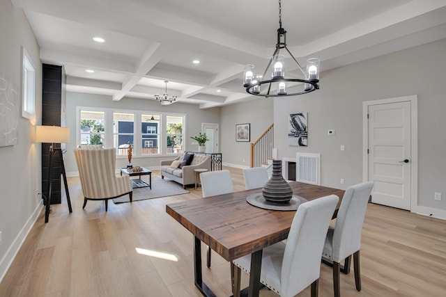 dining space featuring a chandelier, beam ceiling, light wood-type flooring, and coffered ceiling