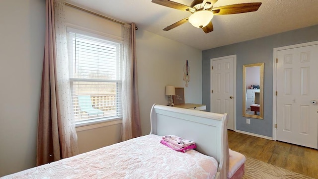 bedroom featuring wood-type flooring and ceiling fan