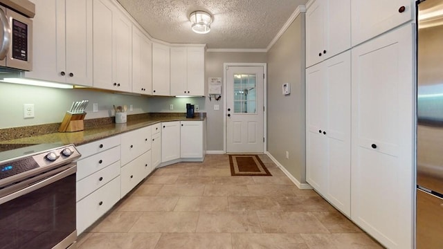 kitchen with a textured ceiling, stainless steel appliances, crown molding, dark stone countertops, and white cabinets