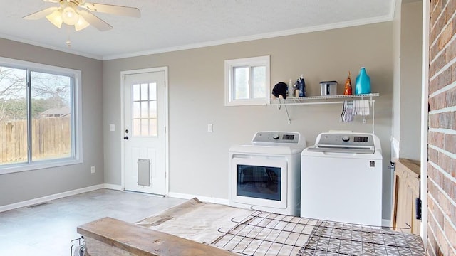 laundry room featuring ceiling fan, crown molding, and washing machine and clothes dryer